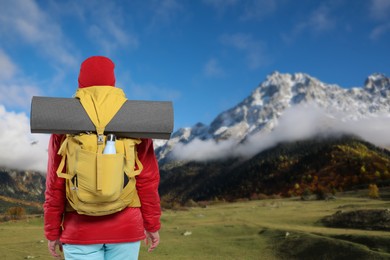 Image of Tourist with backpack in mountains, back view