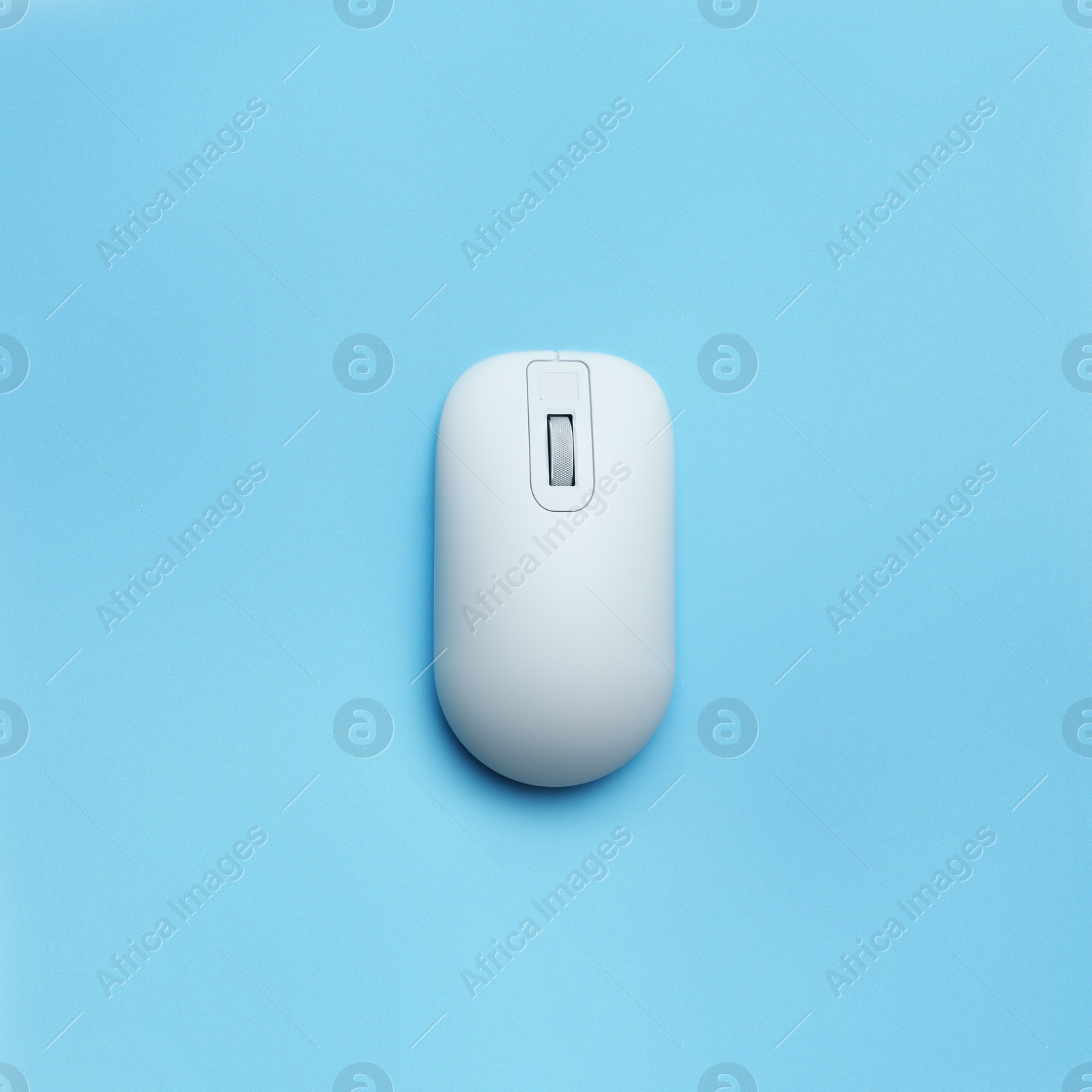 Image of Modern wireless computer mouse on light blue background, top view