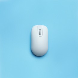 Modern wireless computer mouse on light blue background, top view