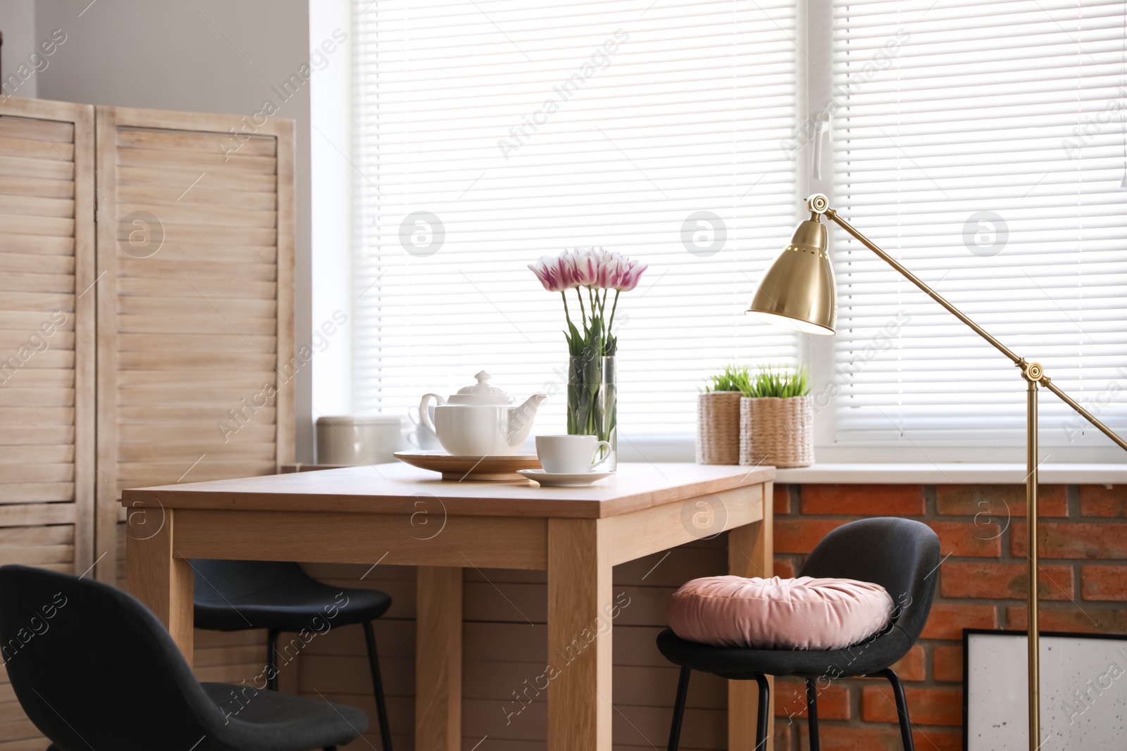 Photo of Stylish room interior with modern furniture and window blinds