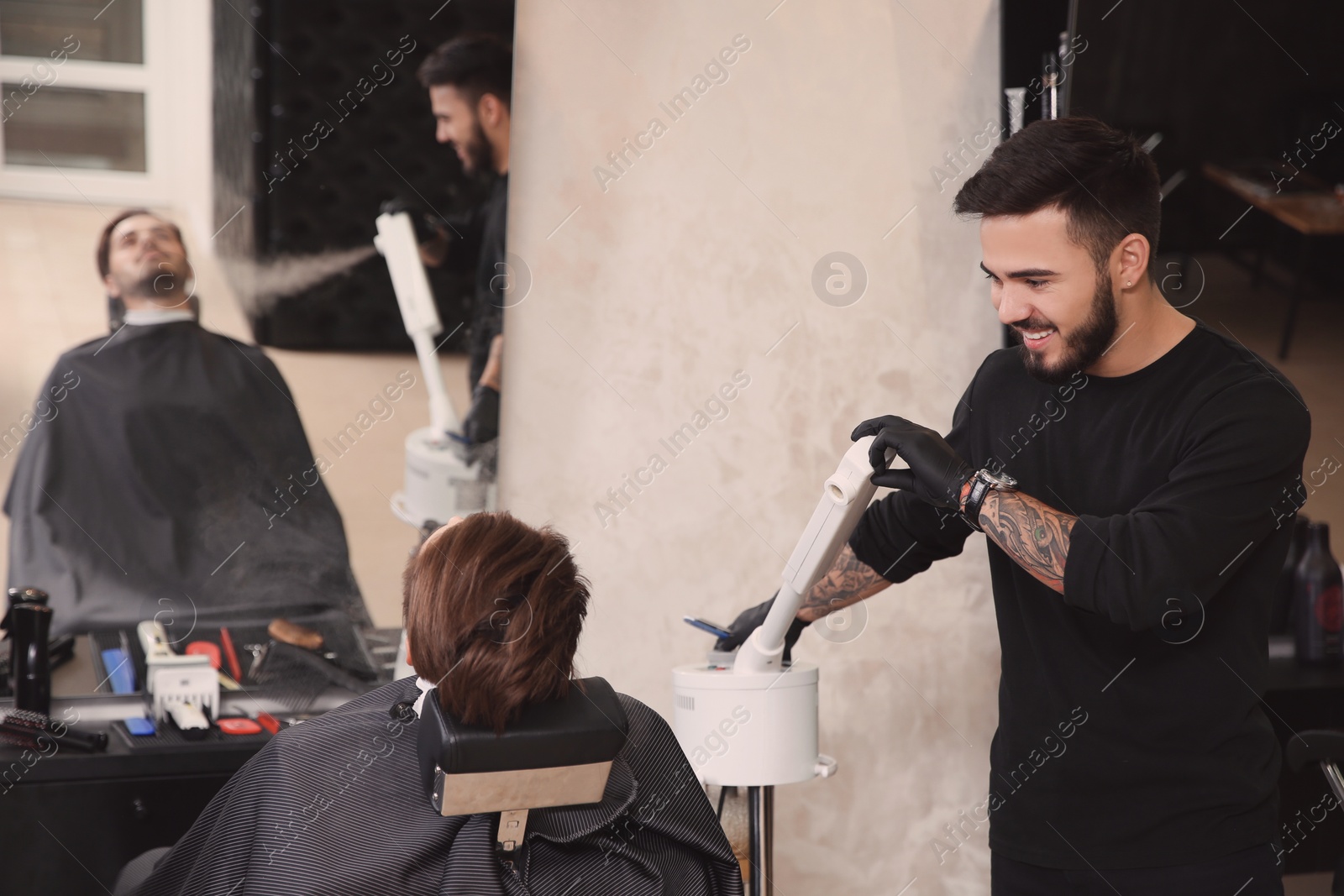 Photo of Hairdresser working with client at barbershop. Professional shaving service