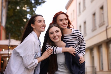 Photo of Portrait of happy friends spending time together outdoors