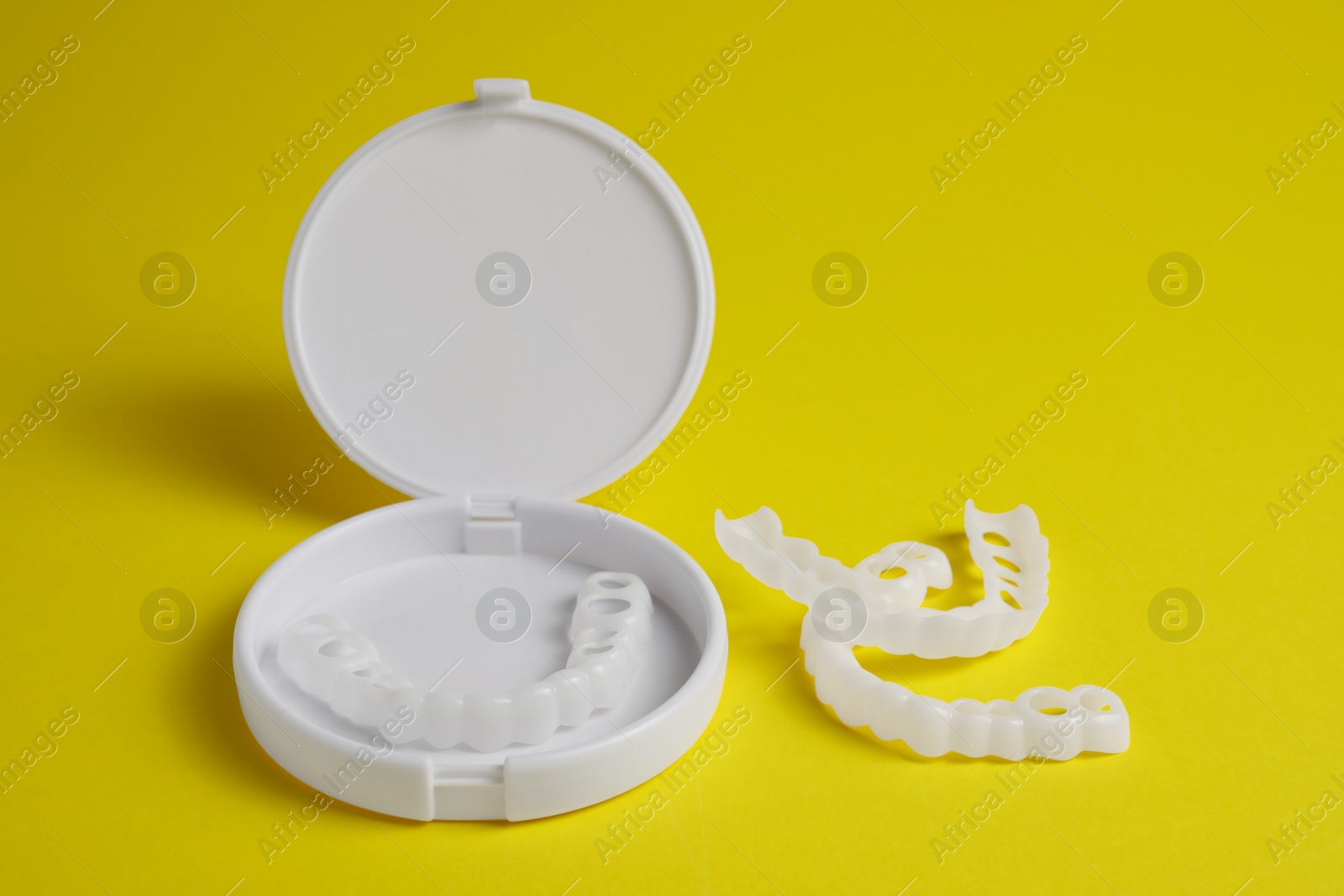Photo of Dental mouth guards on yellow background. Bite correction