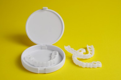 Dental mouth guards on yellow background. Bite correction