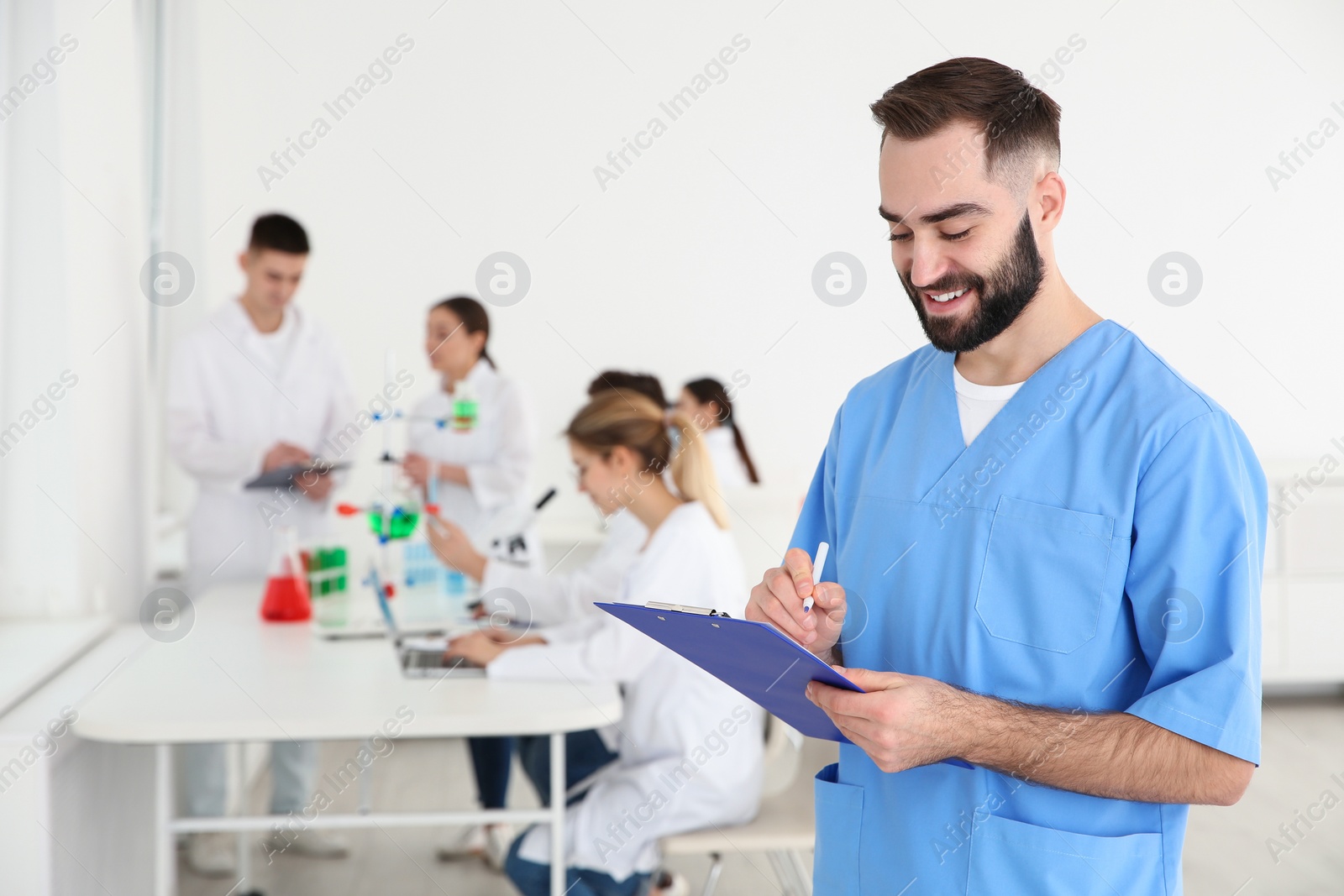 Photo of Portrait of medical student working in scientific laboratory. Space for text