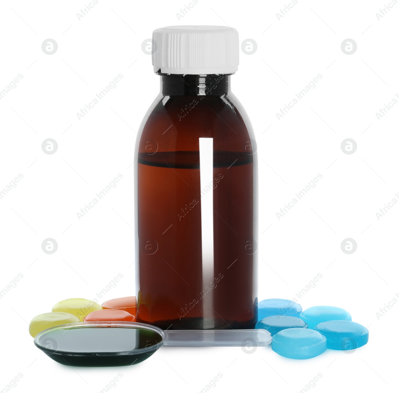 Photo of Bottle of syrup, dosing spoon and cough drops on white background