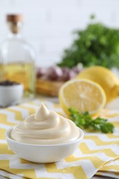 Photo of Tasty mayonnaise sauce in bowl on table. Space for text