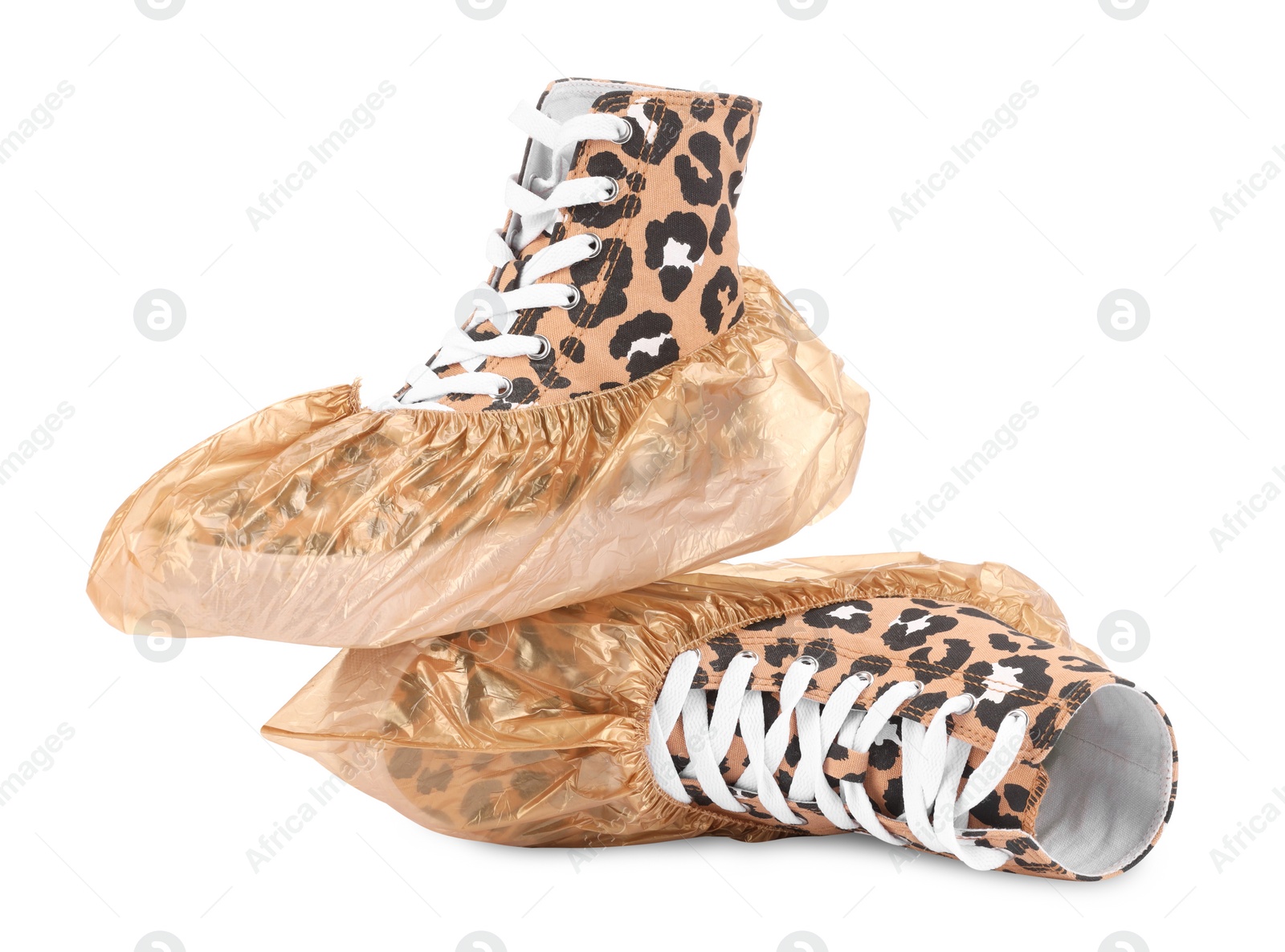 Photo of Sneakers in shoe covers isolated on white