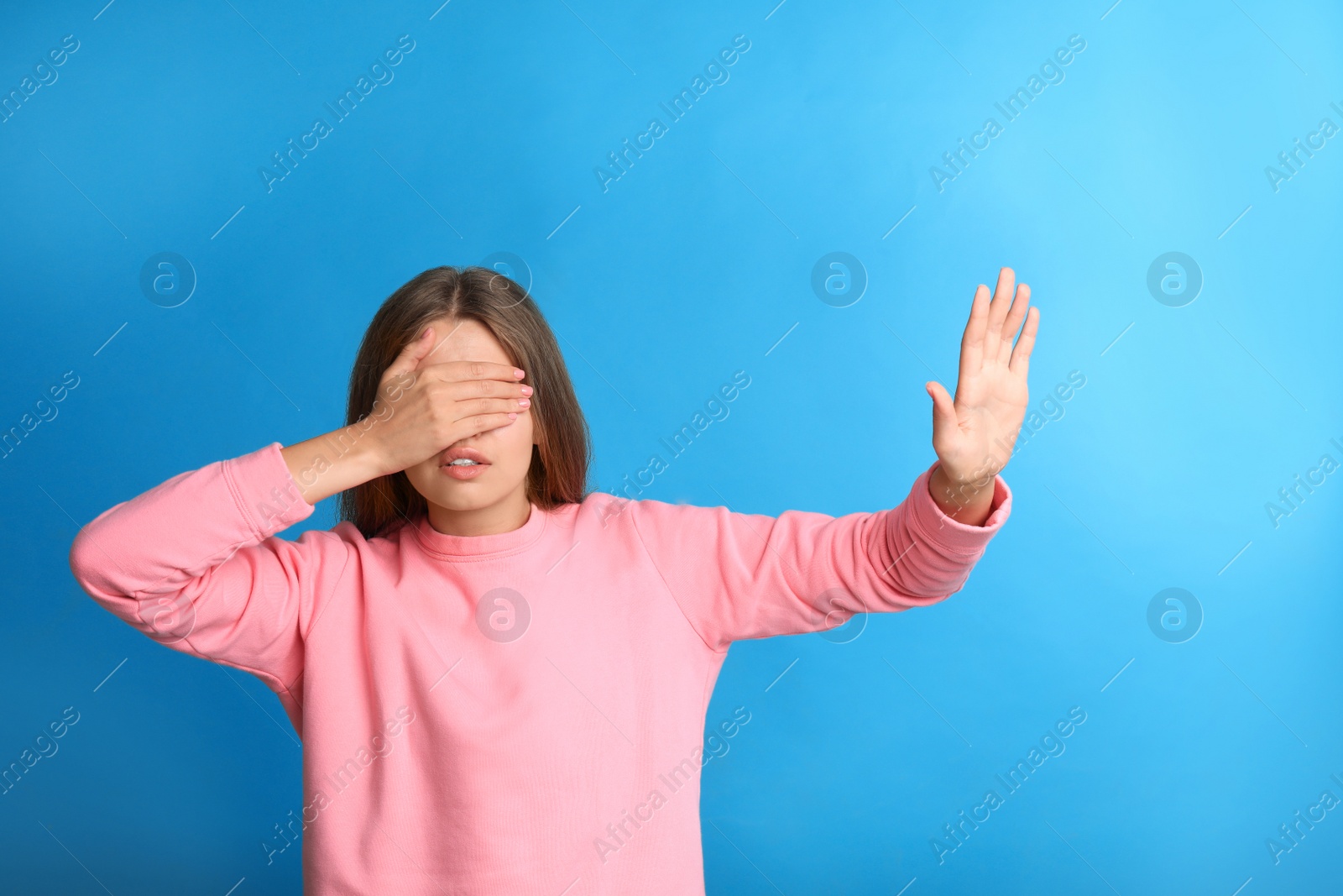 Photo of Young woman being blinded on blue background