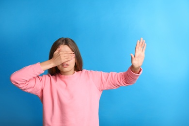 Photo of Young woman being blinded on blue background