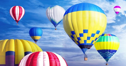 Image of Many bright hot air balloons flying in sky, banner design