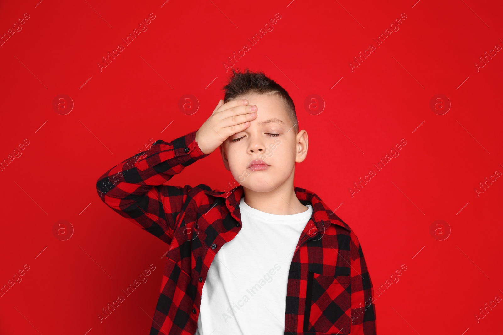 Photo of Portrait of emotional little boy on red background