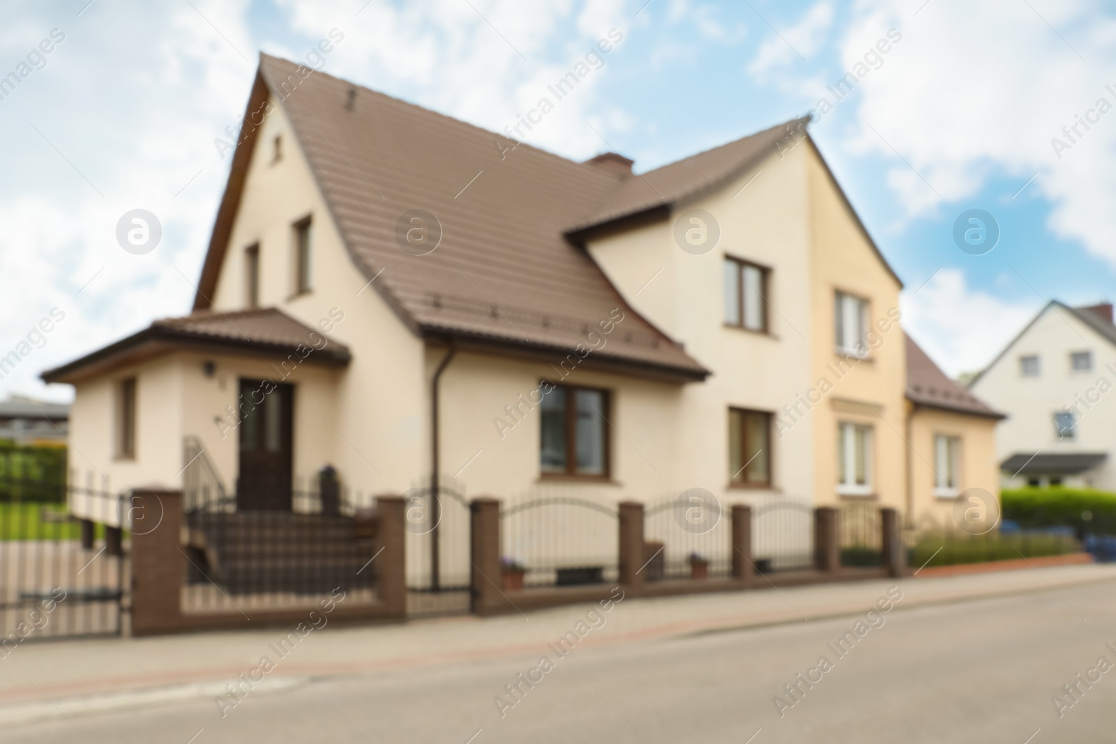 Photo of Blurred view of suburban street with beautiful house