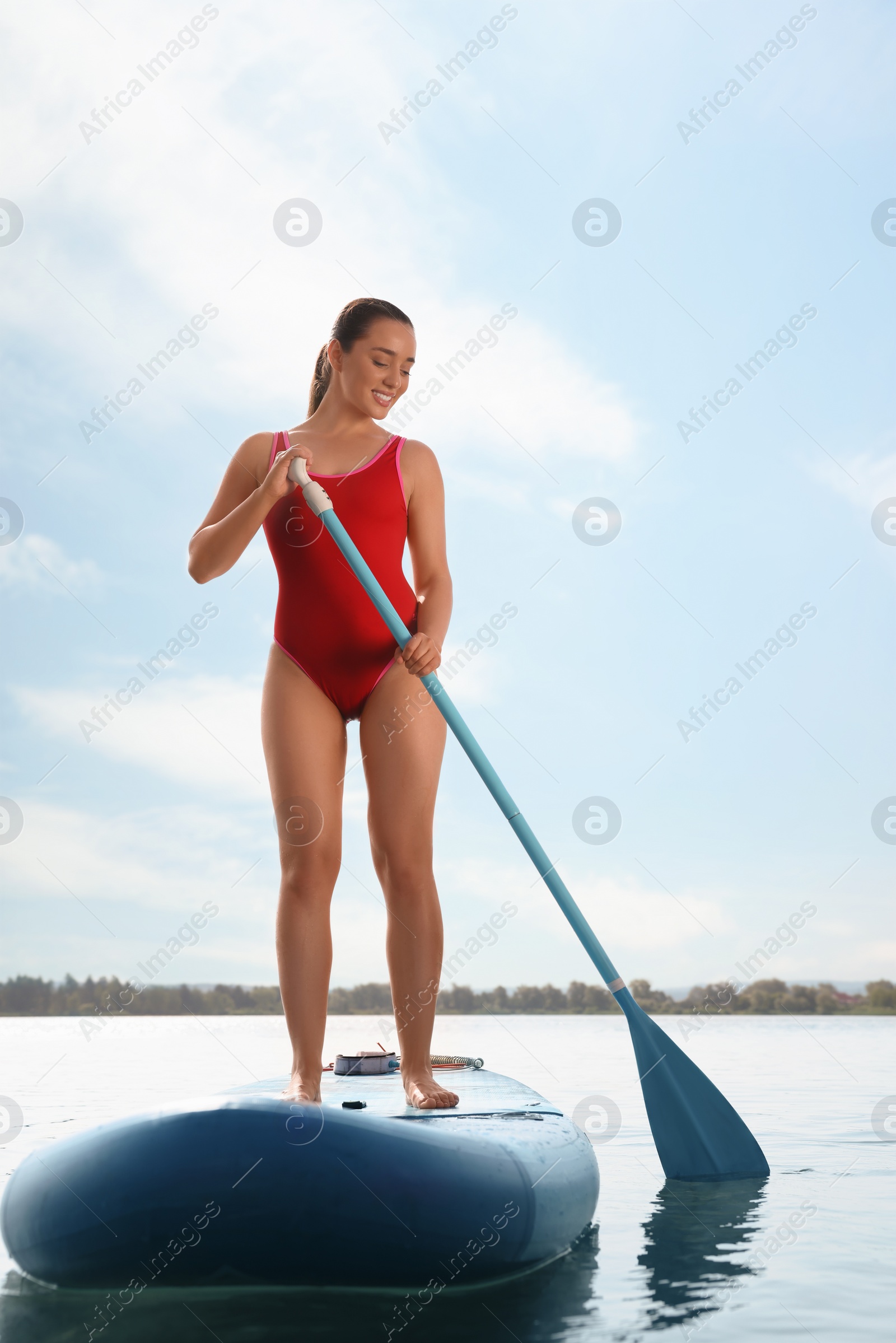 Photo of Woman paddle boarding on SUP board in sea