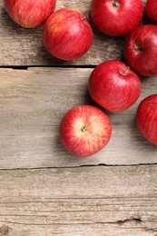 Photo of Fresh red apples on wooden table, flat lay. Space for text