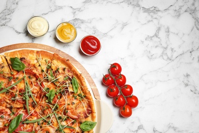 Photo of Flat lay composition with tasty homemade pizza and space for text on table