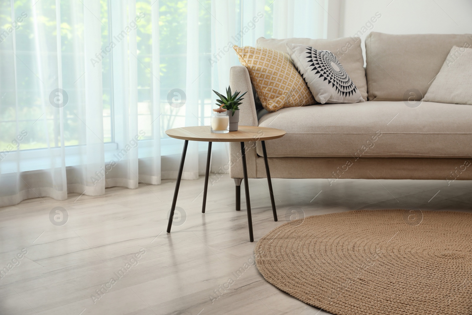 Photo of Living room interior with comfortable sofa and stylish round rug