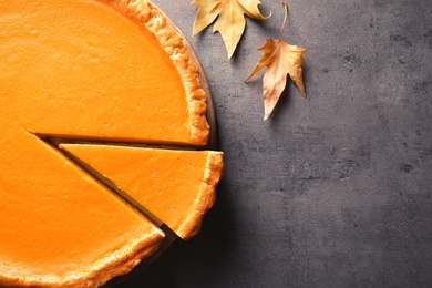 Fresh delicious homemade pumpkin pie on table, top view. Space for text