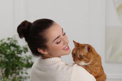 Photo of Beautiful woman with cute cat at home