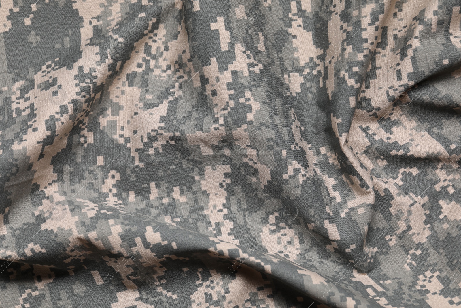 Photo of Texture of crumpled camouflage fabric as background, top view