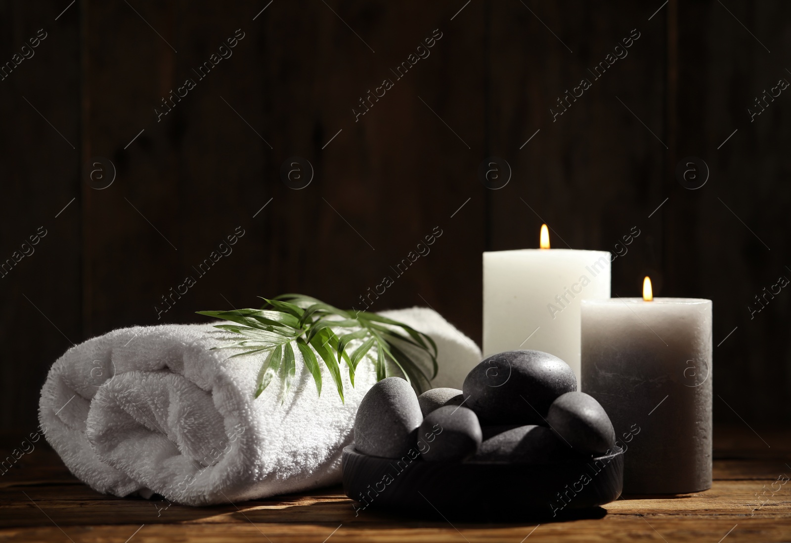 Photo of Composition with spa stones on wooden table