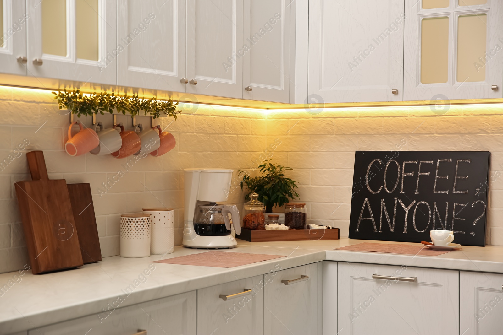 Photo of Stylish kitchen interior with modern coffeemaker on countertop