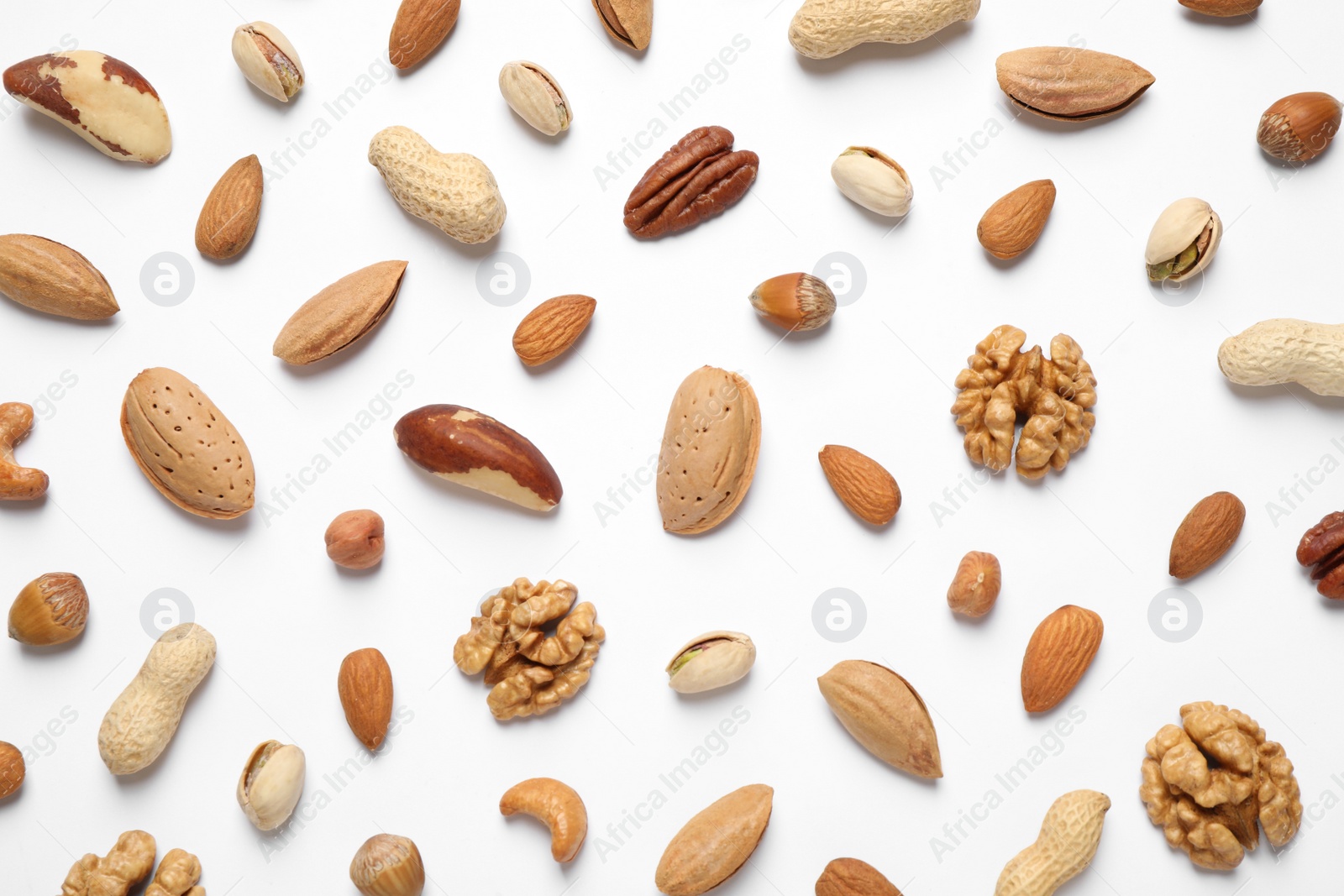 Photo of Different delicious nuts on white background, flat lay