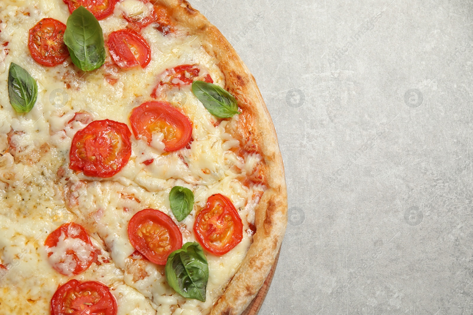 Photo of Delicious pizza Margherita on light grey table, top view. Space for text