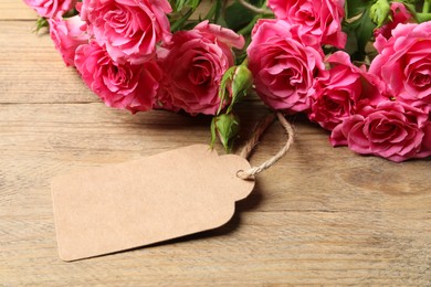 Photo of Happy Mother's Day. Beautiful flowers and blank card on wooden table