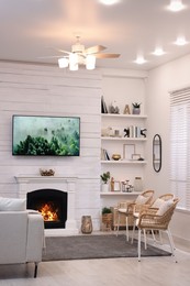 Photo of Cozy living room interior with comfortable sofa and decorative fireplace