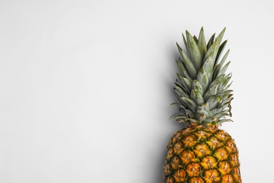 Photo of Tasty whole pineapple with leaves on white background, top view