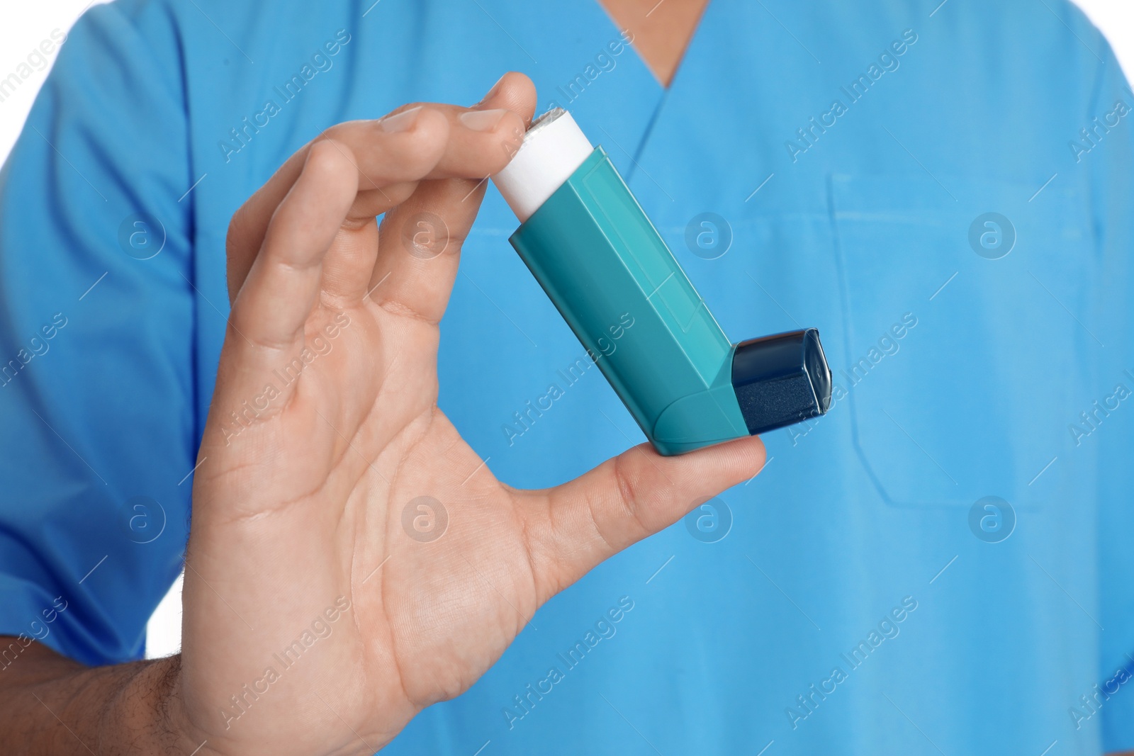 Photo of Male doctor holding asthma inhaler on white background, closeup. Medical object
