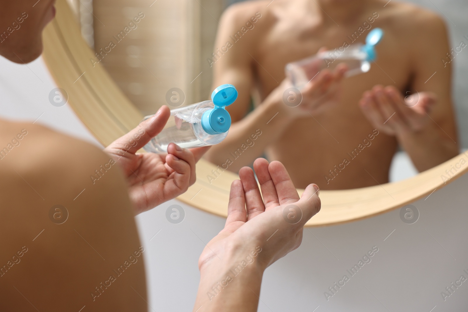 Photo of Man with lotion in bathroom, closeup view