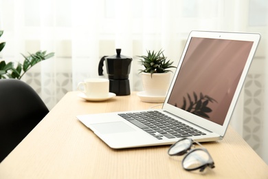 Photo of Cozy blogger workplace with laptop at home