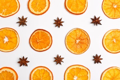 Flat lay composition with dry orange slices and anise stars on white background