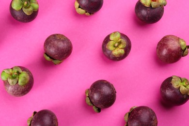 Photo of Fresh ripe mangosteen fruits on pink background, flat lay