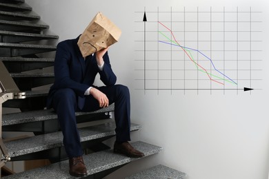 Image of Man wearing paper bag with drawn sad face indoors and illustration of falling down chart. Economy recession concept