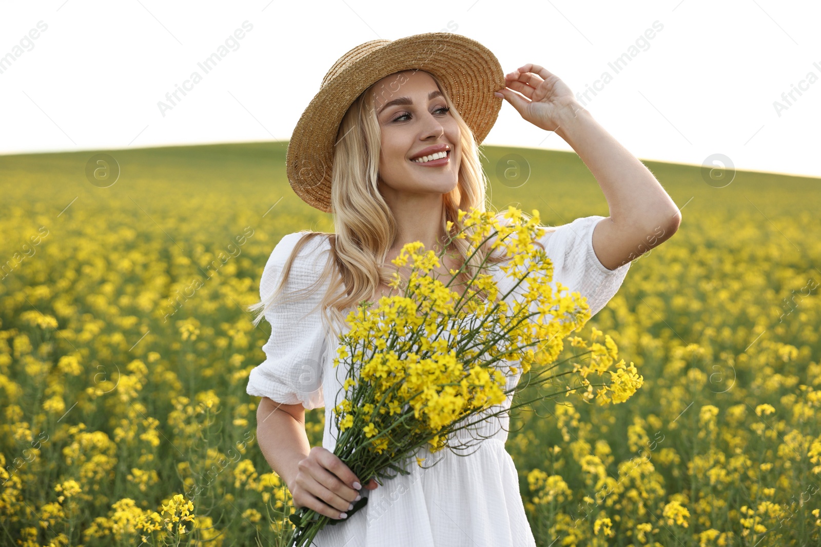 Photo of Portrait of happy young woman in field on spring day