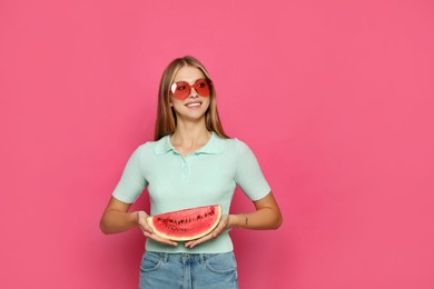 Beautiful girl with slice of watermelon on crimson background