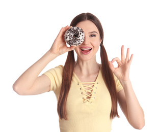 Beautiful young woman with donut on white background