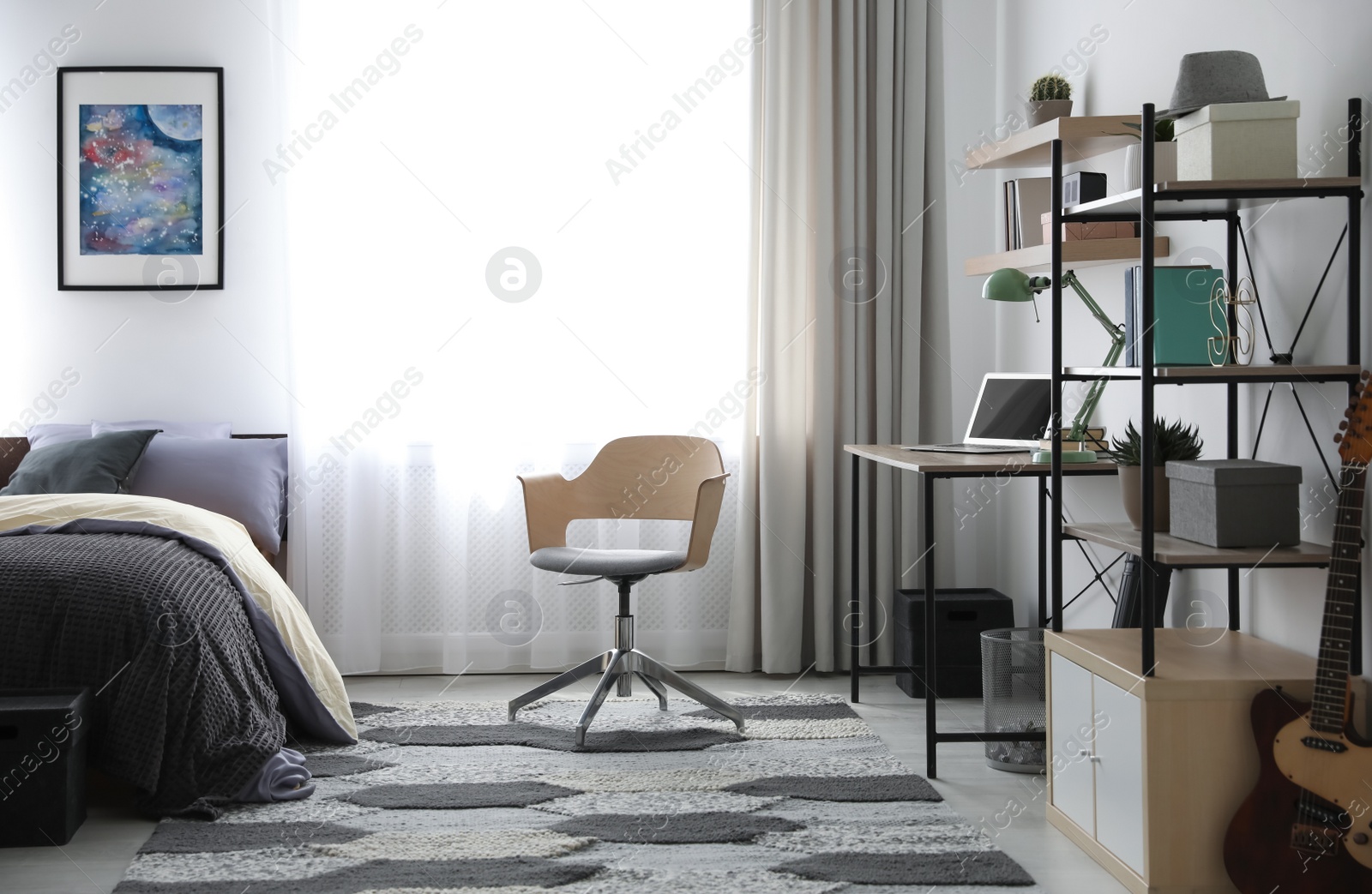 Photo of Modern teenager's room interior with workplace and bed