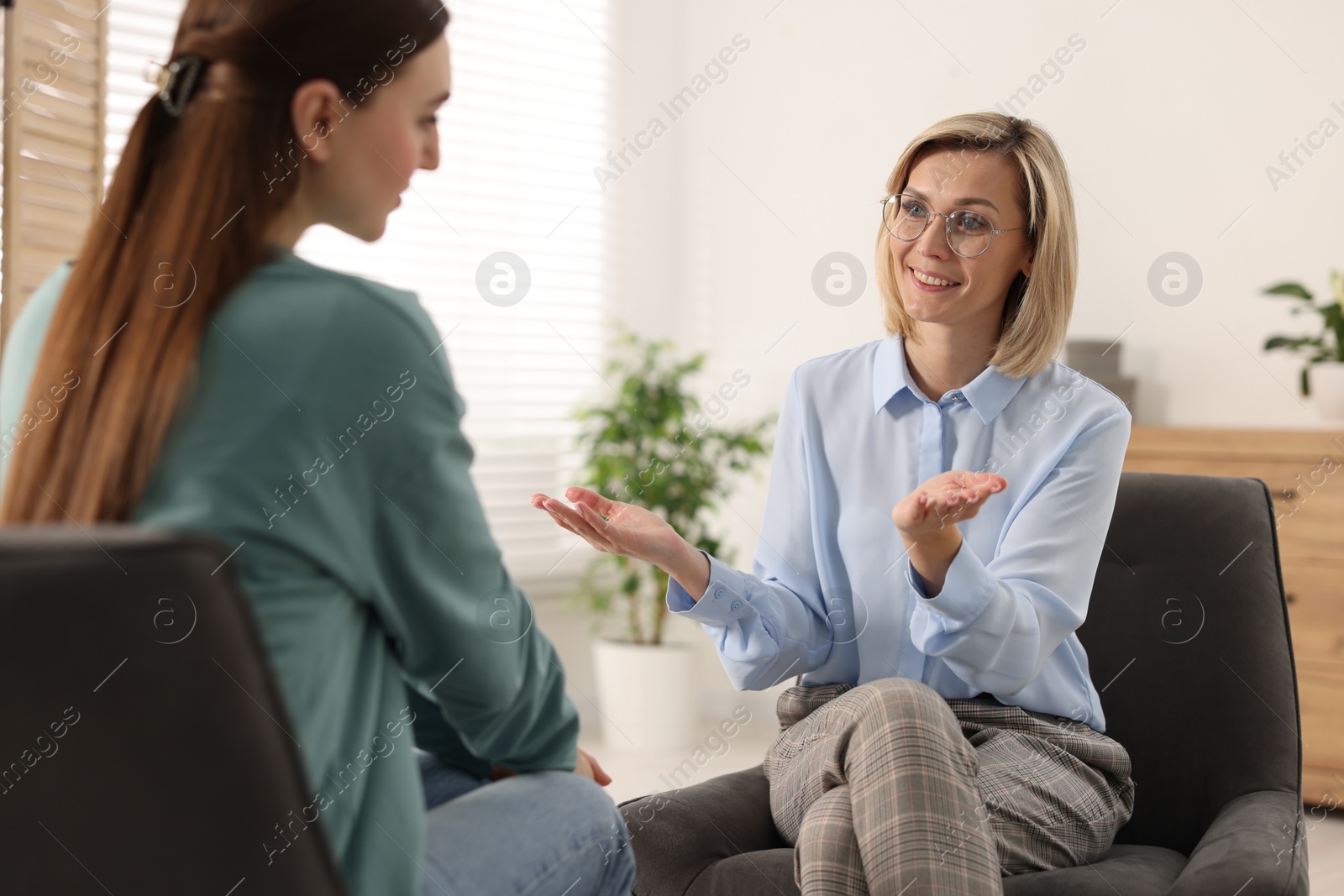 Photo of Professional psychotherapist working with patient in office