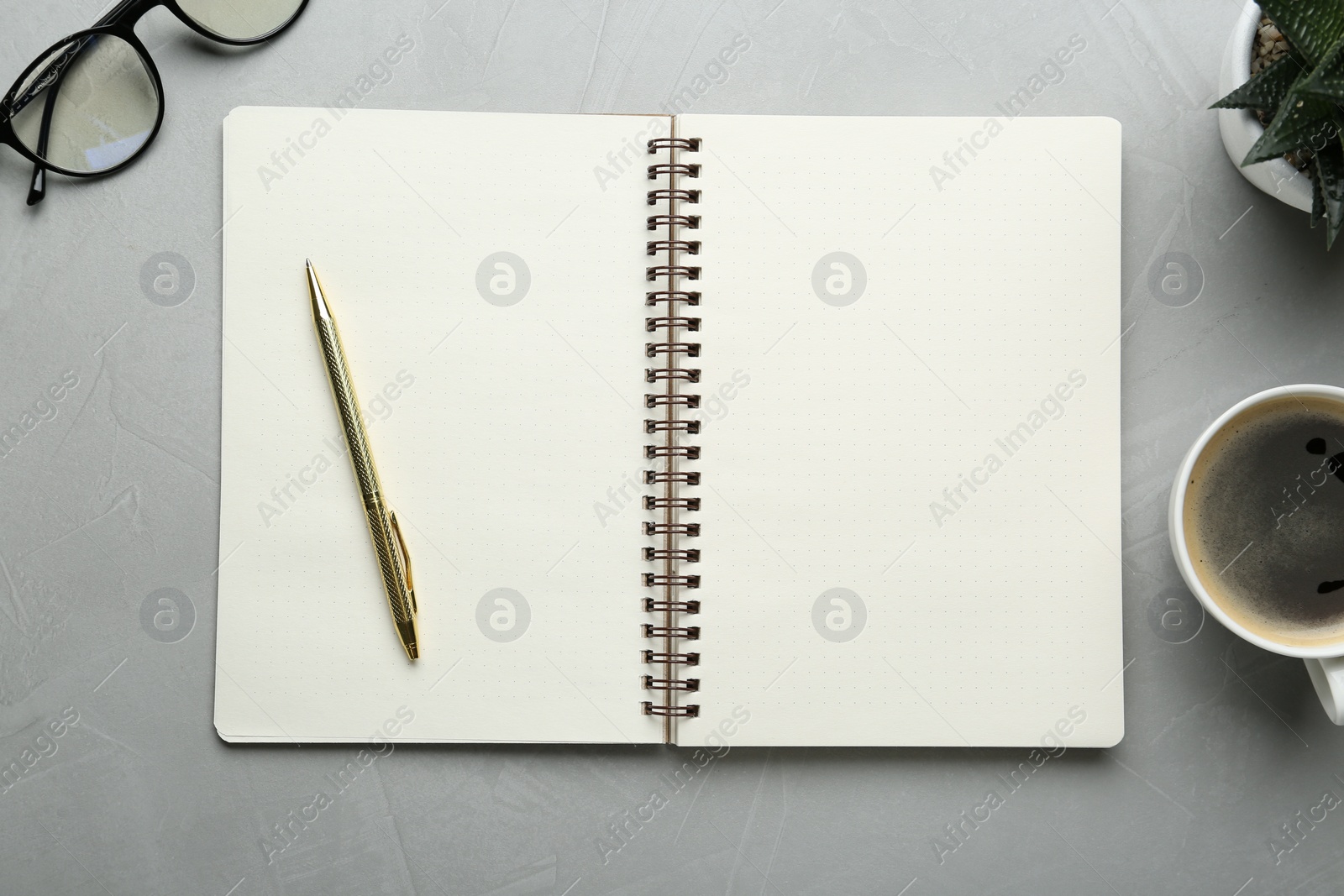 Photo of Flat lay composition with open notebook on light textured table. Space for text