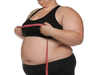 Overweight woman measuring her chest with tape on white background, closeup