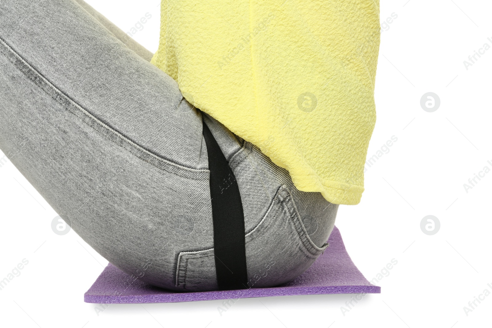 Photo of Woman sitting on foam tourist mat against white background, closeup