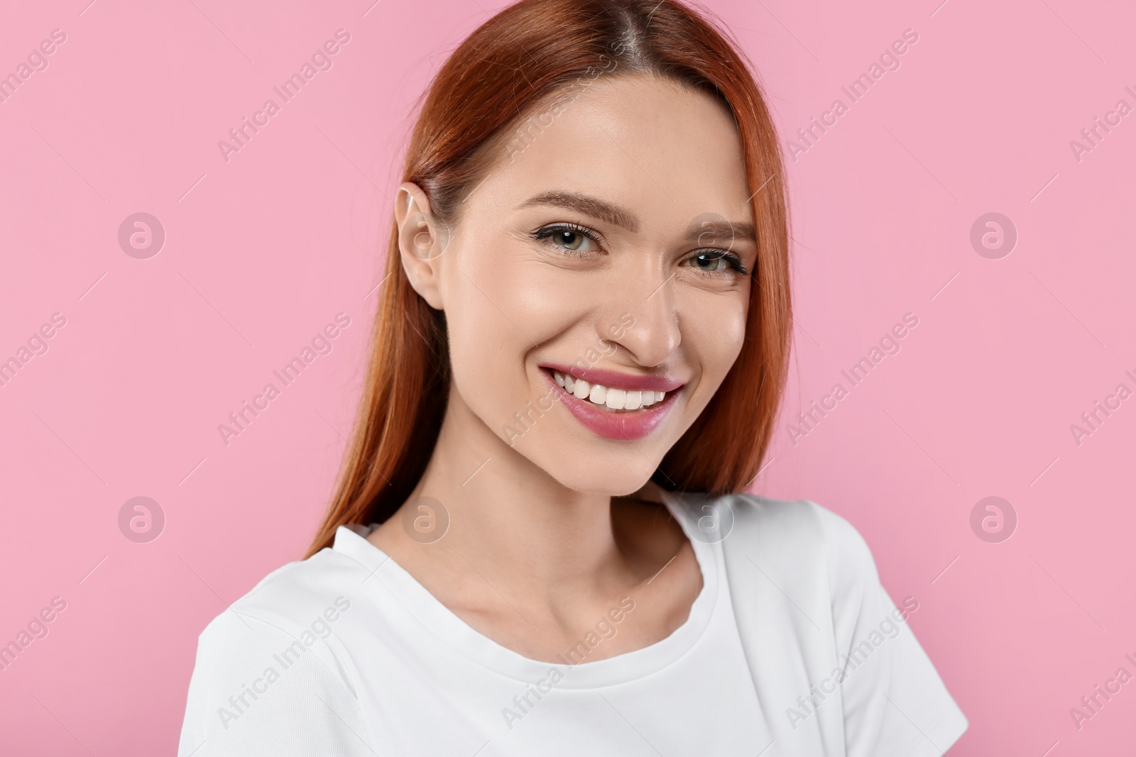 Photo of Portrait of beautiful young woman on pink background