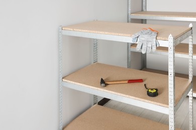 Photo of Metal storage shelf with room renovation tools in office