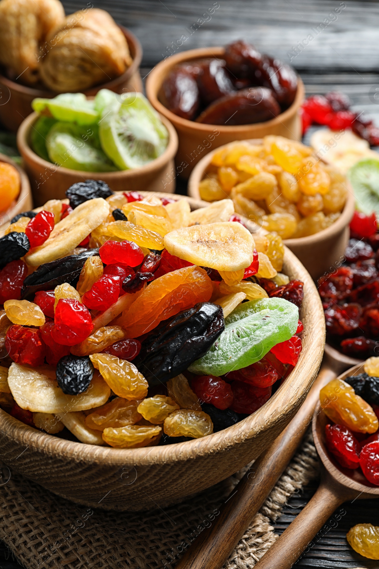 Photo of Composition with different dried fruits on wooden background. Healthy lifestyle