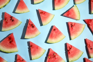 Photo of Watermelon slices on light blue background, flat lay