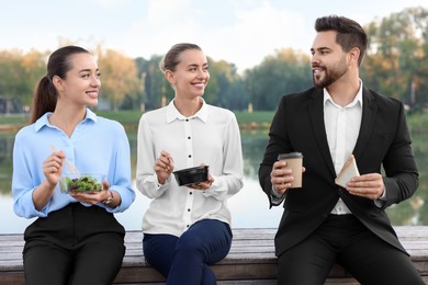 Photo of Business people spending time together during lunch outdoors